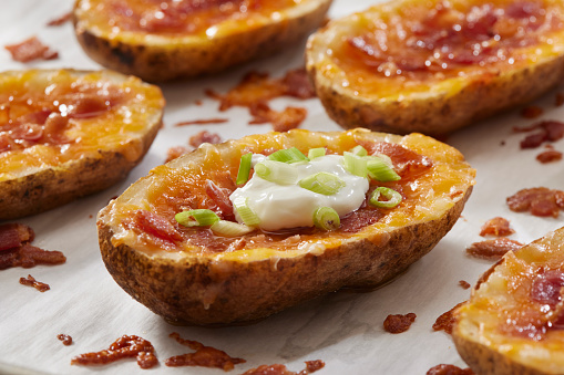 Loaded Potato Skins with Cheddar Cheese, Bacon, Green Onions and Sour Cream