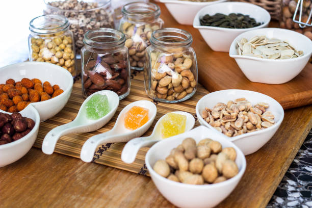 istock Assortment of nuts on rustic wood table 1422861787