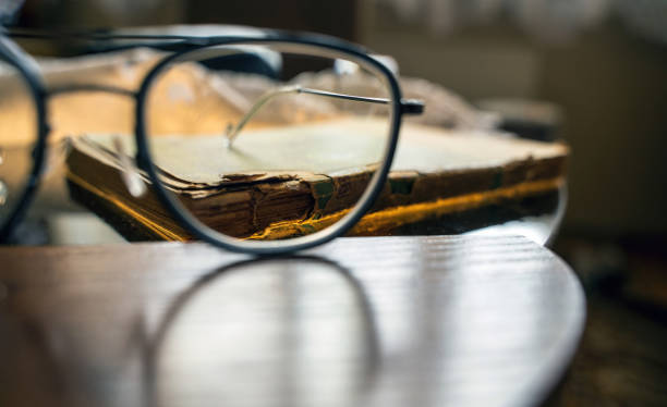 istock Time and knowledge concept, An eye glasses or spectacle against old book 1422865706