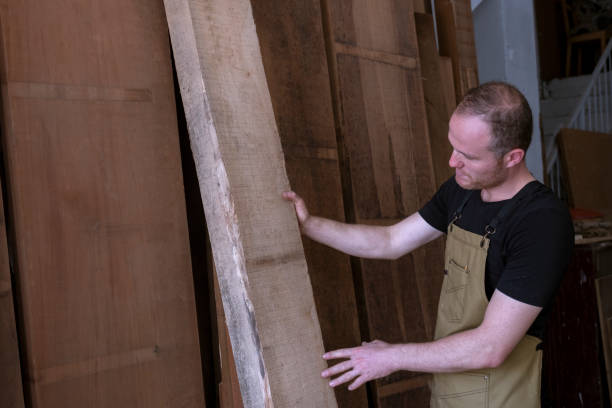 istock young male carpenter chooses wood for processing 1422866656