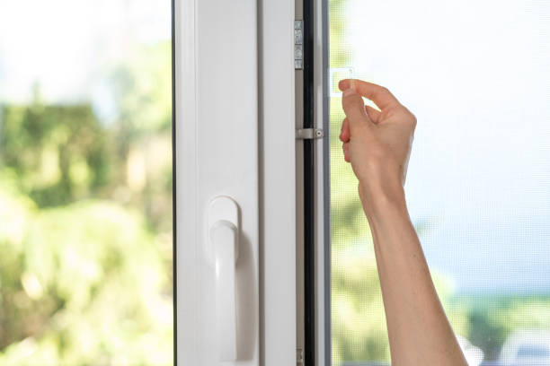 istock woman installing mosquito net for plastic window 1422868526