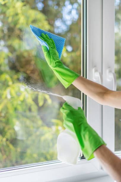 istock gloved hands cleaning window glass with detergent 1422868996
