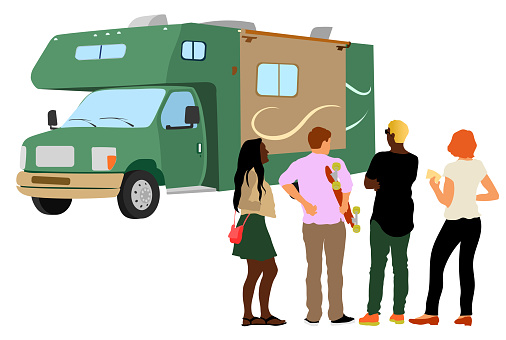 Large camper with people standing in front.