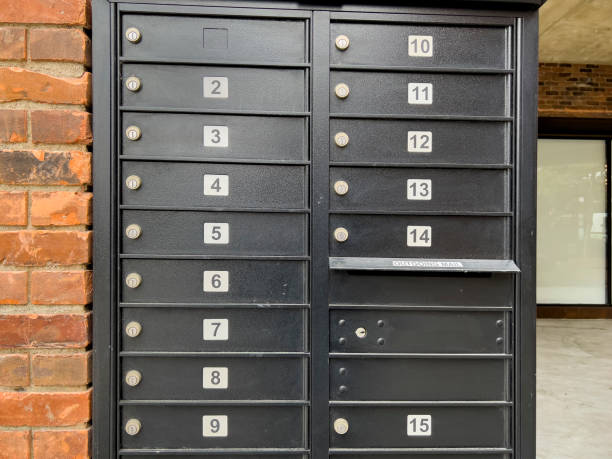 Numbered, black mailboxes infront of a building stock photo