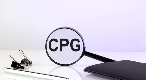 istock CPG - Consumer Packaged Goods concept. Magnifier glass with text with notebook and pen 1422871901