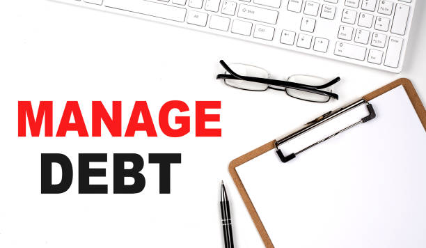 istock MANGE DEBT text written on the white background with keyboard, paper sheet and pen 1422871933