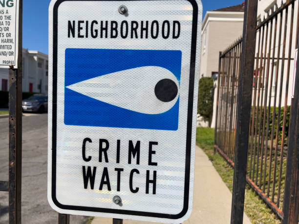 Neighborhood crime watch sign on a fence stock photo