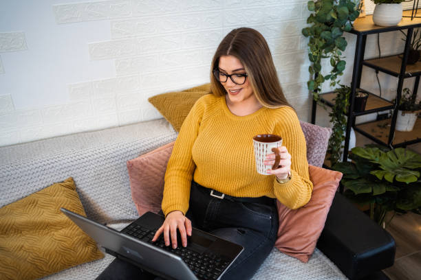 istock Woman at home using laptop and drink tea 1422873861