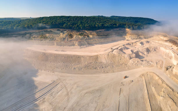 istock Aerial view of open pit mining site of limestone materials extraction for construction industry with excavators and dump trucks. 1422876256