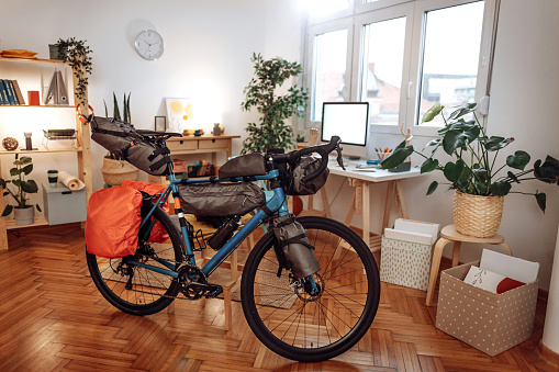 Mountain bike packed for a trip in a empty apartment