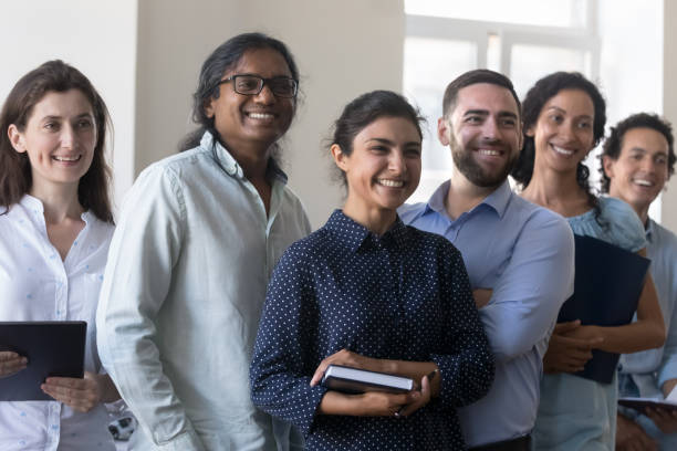 istock Happy cheerful multiethnic business project team standing together in office 1422877519