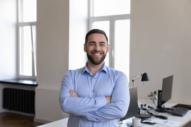 istock Happy handsome businessman looking at camera, smiling posing 1422877559