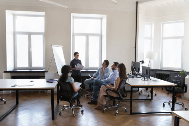 istock Presenter woman training diverse group of employees 1422877649