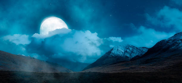 istock Magical Night Scene with Full Moon in cloudy sky. Mountain Landscape from Yukon 1422877837