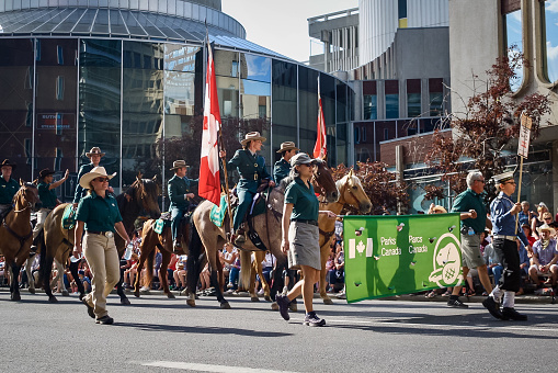 Calgary, Canada - July, 2019:  Parks Canada featured in the (Calgary) Stampede Parade coming through downtown. The parade marks the start of the Calgary Stampede rodeo festival. Taken in July 2017.