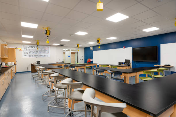 Example of an empty nondescript US High School Classroom with desks, chairs and white board. Example of a new empty nondescript US High School science classroom with desks and white board.  Classroom could be in almost any US High School.  Nobody included in image and all logos have been removed. classroom empty education desk stock pictures, royalty-free photos & images