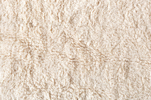 istock Beige soft ecological fur textile background, closeup 1422885235