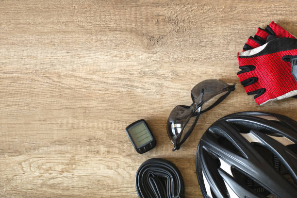istock Bicycle accessories on a brown wooden background in the corner 1422888103