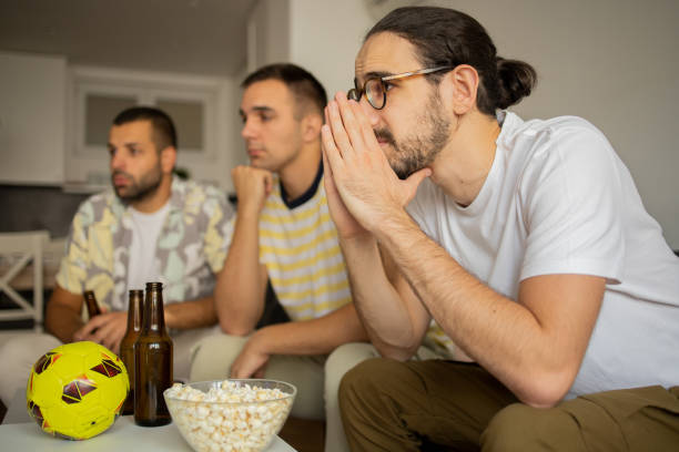 istock Friends together watching TV at home 1422888486
