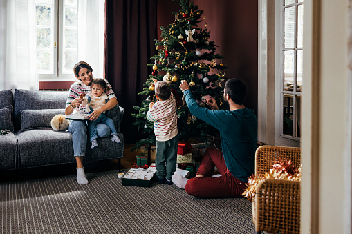 Christmas family time: a happy family at home during winter holidays.