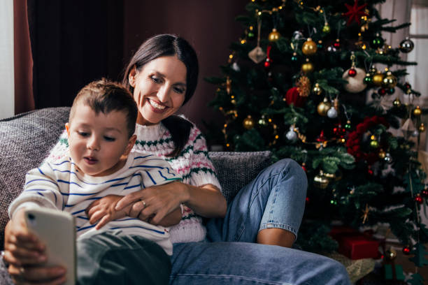 istock Mother and Son Ordering Something Online Together at Christmastime 1422890332