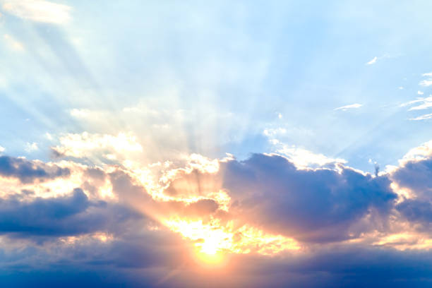 istock Rays of evening sun in dark blue clouds 1422893971