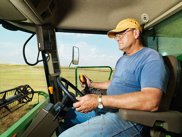 istock Farmer in combine harvesting crop. 142290151