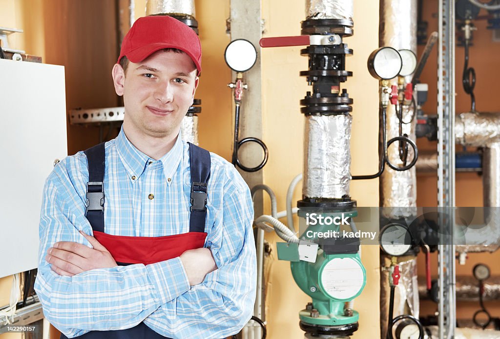 heating engineer repairman in boiler room maintenance repairman engineer of heating system equipment in a boiler house Adult Stock Photo
