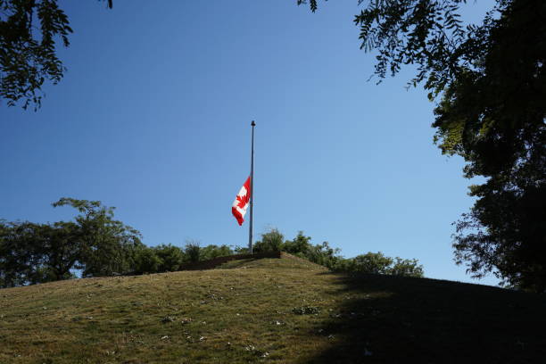 istock Canadian flag raise in half 1422905700
