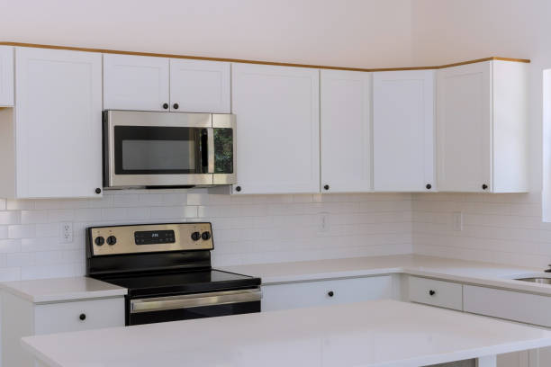 istock New kitchen appliances and kitchen cabinets are being installed in a newly constructed house 1422908094