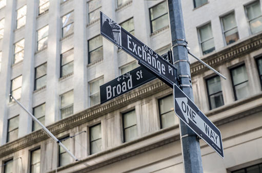 Broad and Exchange Street sign in New York city during summer day