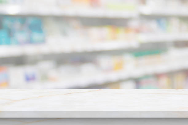 istock Empty white marble counter top with blur pharmacy drugstore shelves background 1422911624