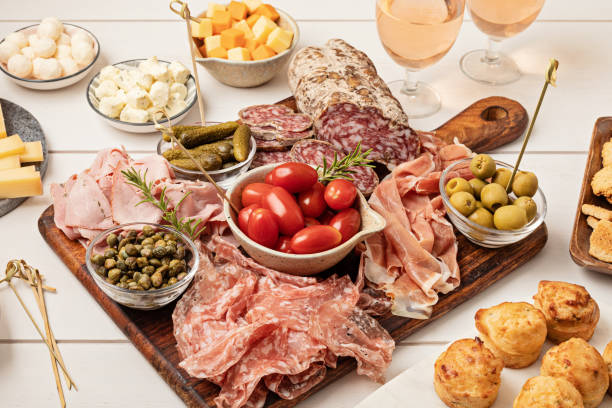 istock Appetizers table with different antipasti, charcuterie, snacks, cheese. Finger food for buffet party. Traditional french or italian entires. Top view 1422911976
