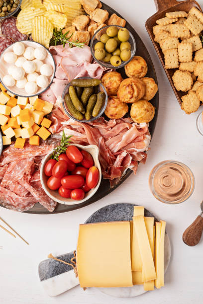 istock Appetizers table with different antipasti, charcuterie, snacks, cheese. Finger food for buffet party. Traditional french or italian entires. Top view 1422911989