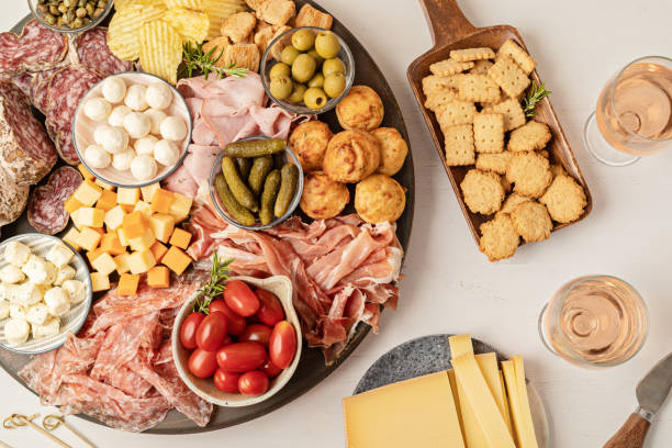istock Appetizers table with different antipasti, charcuterie, snacks, cheese. Finger food for buffet party. Traditional french or italian entires. Top view 1422912031