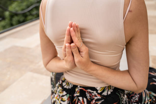 istock one woman alone doing yoga stretching relaxation exercise at balcony 1422915652