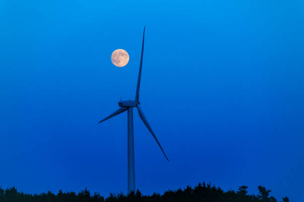 Moonrise over a lone wind turbine in Dexter Minnesota USA