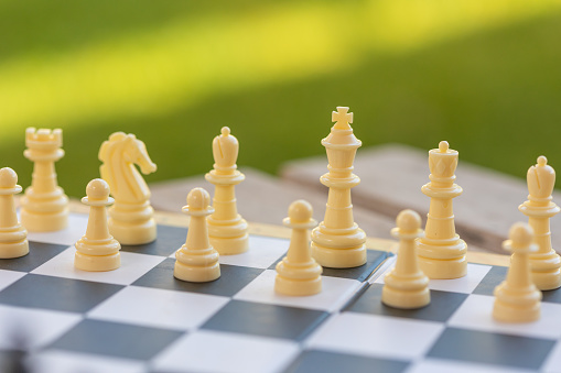 Details of a chess game being played outdoors