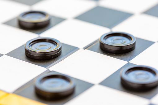 Draughts board game details being played outdoors