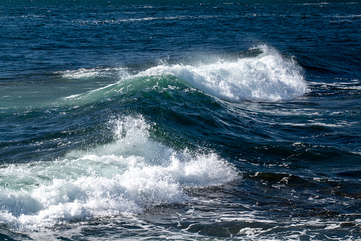 foamy waves rolling up in ocean