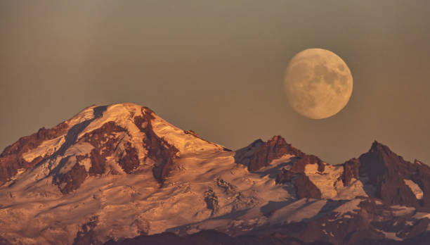 istock snow mountain with moonrise at sunset 1422931975