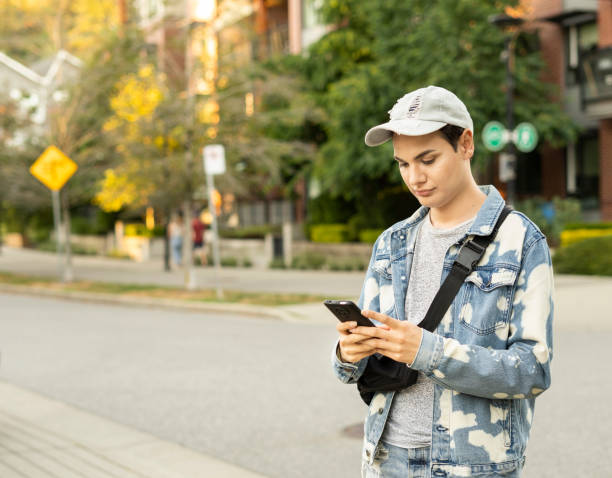 istock Person standing in the city, using their cellphone 1422934952