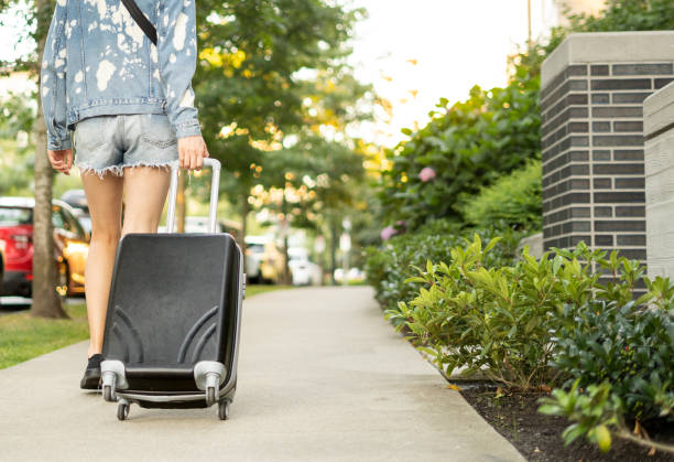 istock Person walking away with suitcase 1422934957