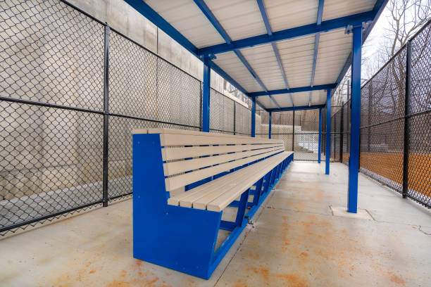 istock View of typical nondescript high school softball clay infield with image from inside the first base dugout.  No people visible.  Not a ticketed event. 1422935484