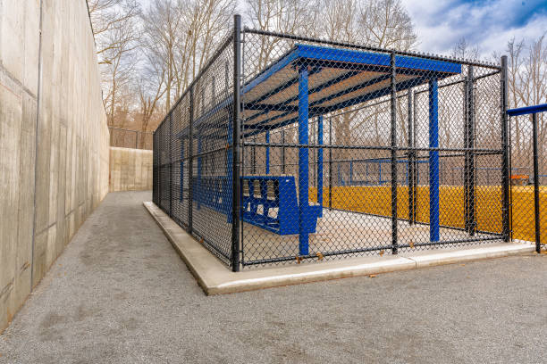 istock View of typical nondescript high school softball clay infield from behind the first base dugout.  No people visible.  Not a ticketed event. 1422936164