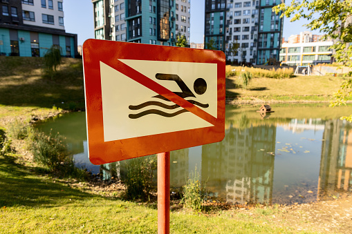 No swimming sign board near the lake in the residential buildings district