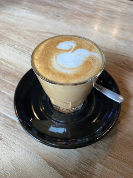 istock A cup of cappucino cofee and spoon on the table 1422939116