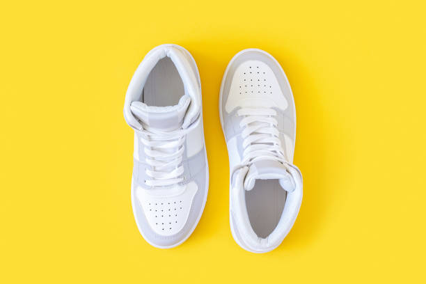 Sports shoes, sneakers with shoelaces on a yellow background. Sport lifestyle concept Top view Flat lay stock photo