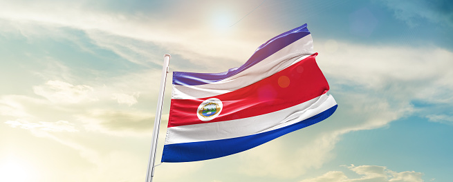 Costa Rica national flag waving in beautiful sky.