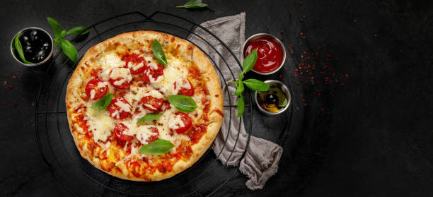 istock Freshly baked pizza on dark background. 1422947493